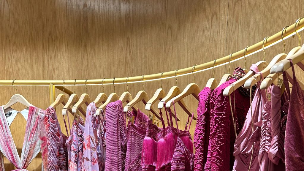 Colourful graduation dresses hanging on a clothing rack