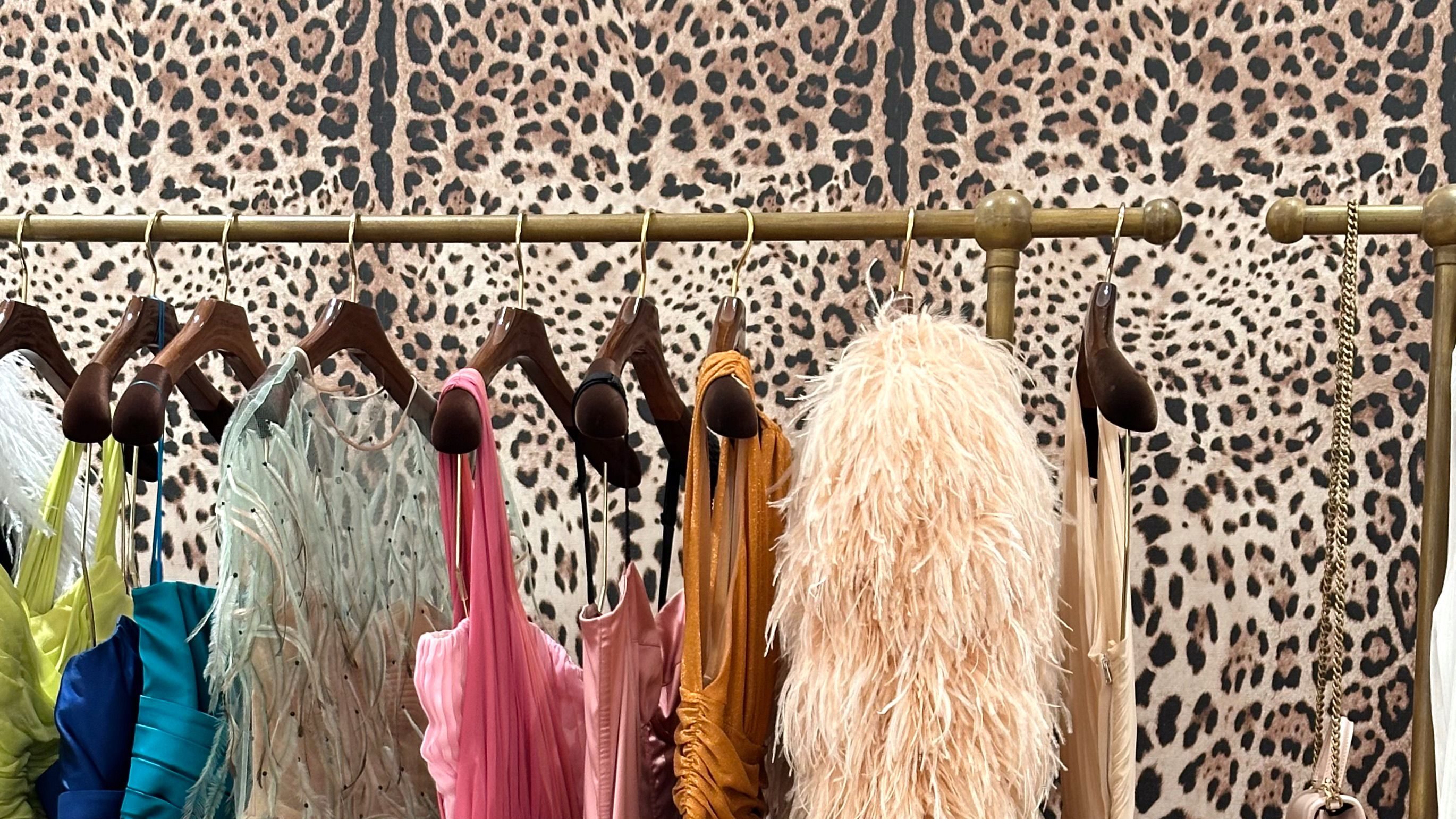 Colorful formal graduation dresses on a clothing rack